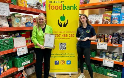 Chrissy Presents Volunteer Award At Food Bank